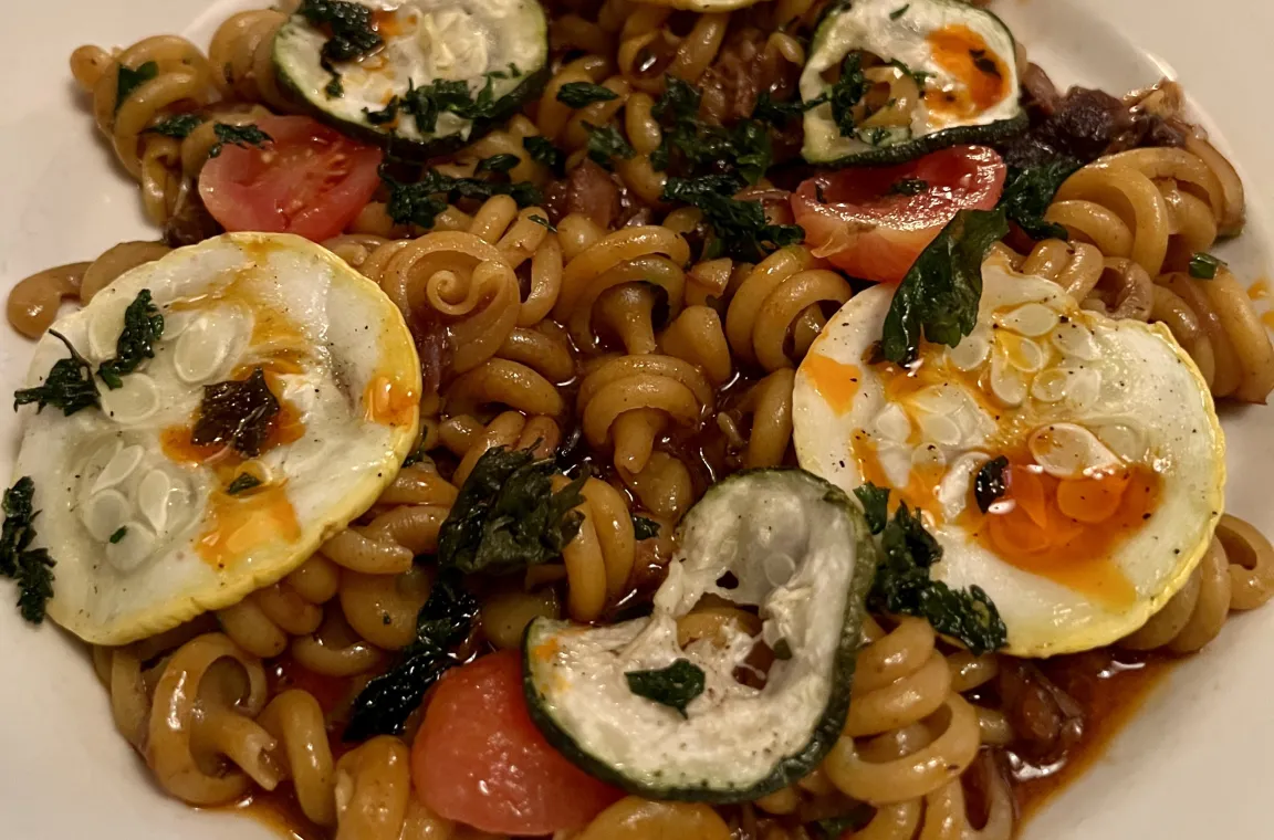 Bowl of cavatelli pasta with slow-cooked beef, roasted tomatoes, basil, squash, and fresh ricotta served at The Charles in Dallas.