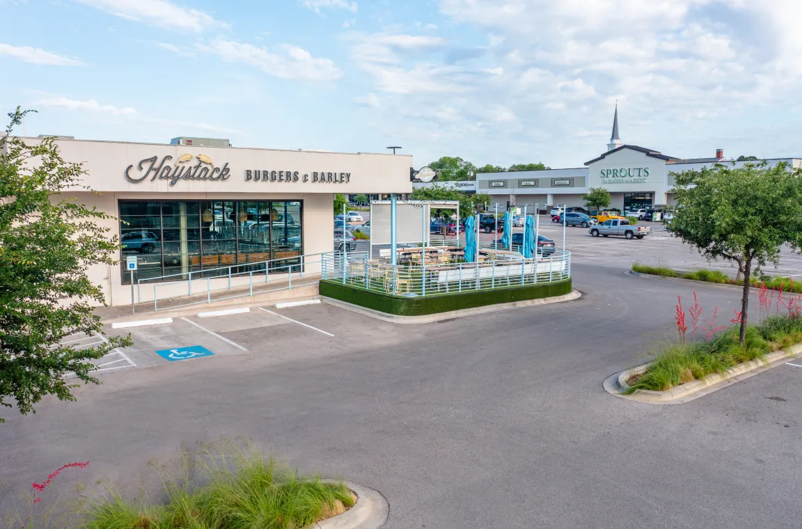 Haystack Burgers & Barley storefront, with several other storefronts in Hillside Plaza in the background