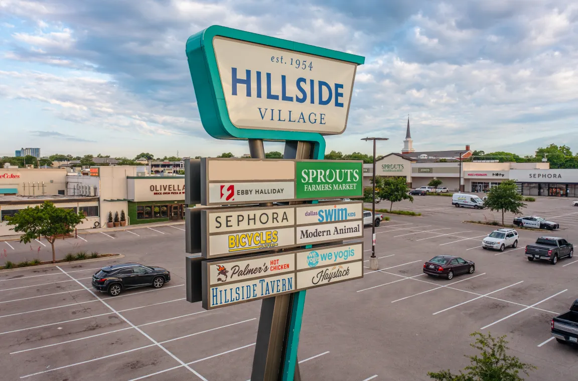 Hillside Village main sign, with several store signs below