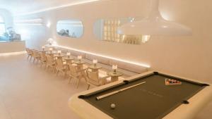 An interior photo of a La La Land location featuring a customer seating area and a pool table.